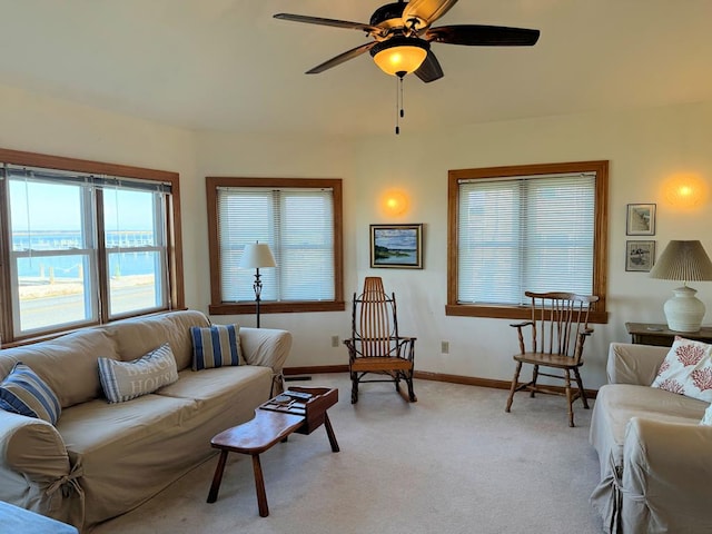 living room with light colored carpet and ceiling fan