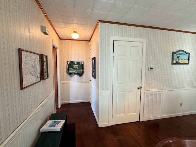 corridor with crown molding and dark hardwood / wood-style flooring