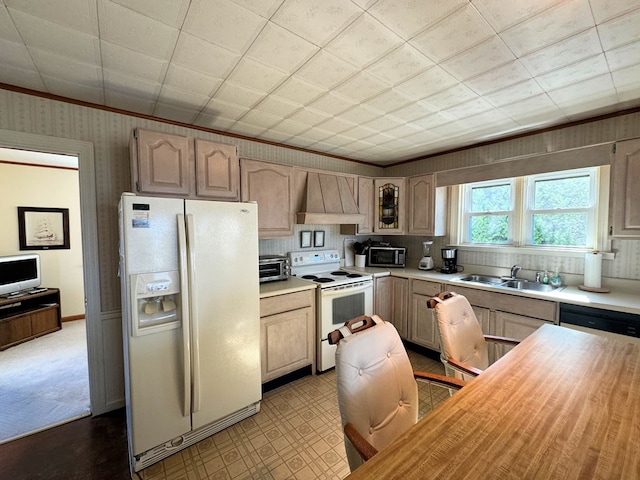 kitchen featuring sink, white appliances, crown molding, premium range hood, and light brown cabinetry