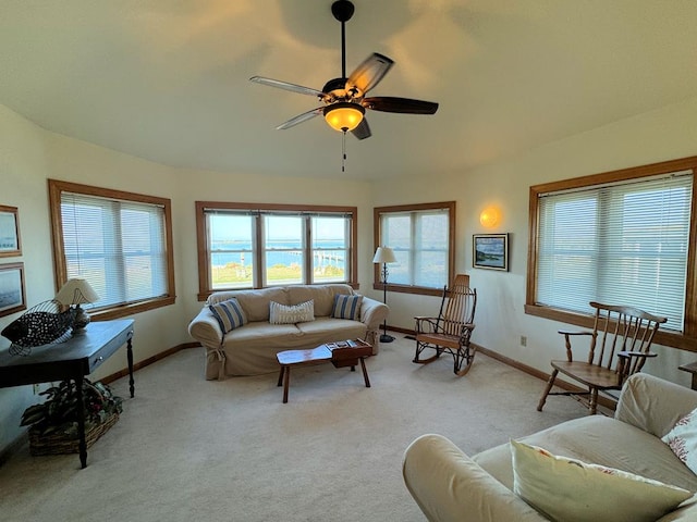 living room with light colored carpet and ceiling fan