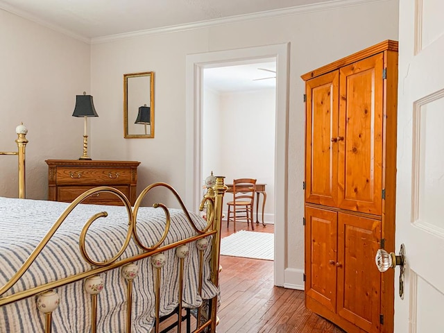 bedroom featuring hardwood / wood-style flooring and ornamental molding