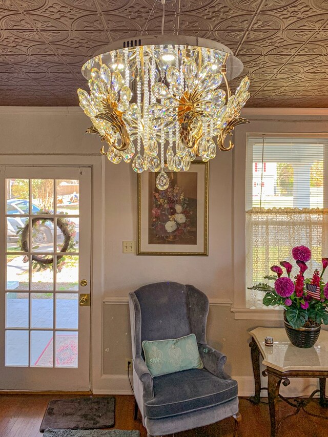 sitting room featuring wood-type flooring and a notable chandelier