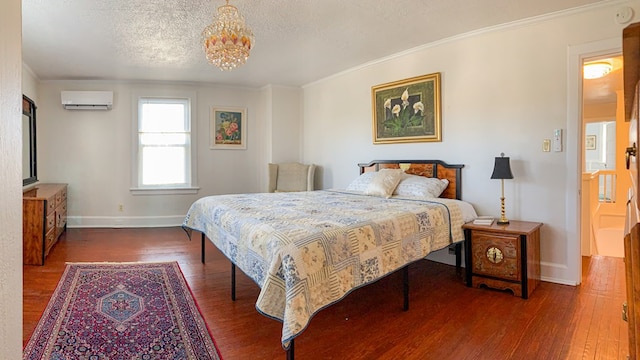 bedroom with a textured ceiling, dark wood-type flooring, crown molding, an AC wall unit, and a notable chandelier