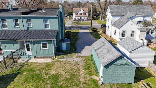 rear view of property featuring a lawn