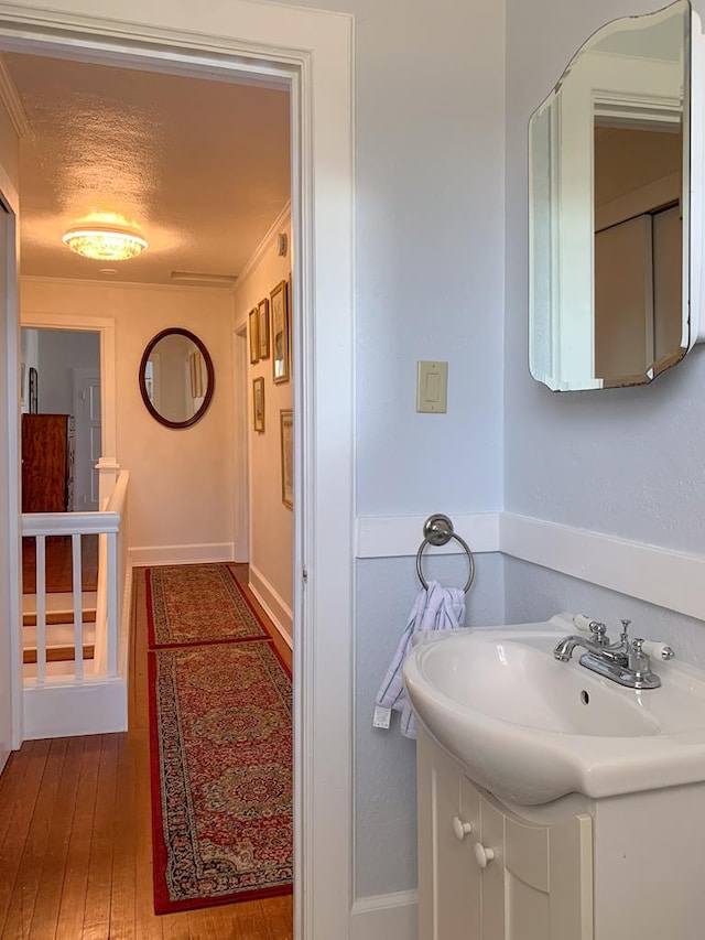 bathroom with vanity, a textured ceiling, and hardwood / wood-style flooring