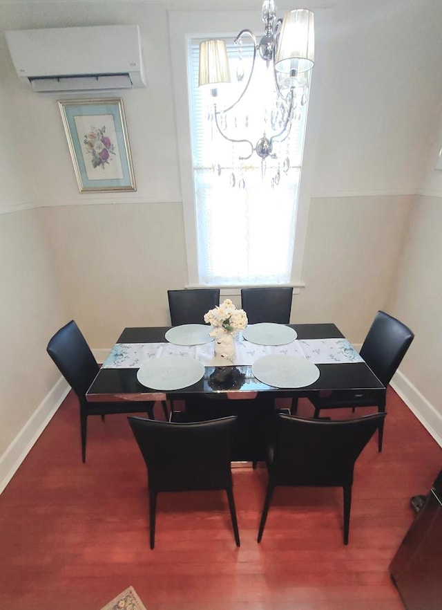 dining area featuring a wall mounted air conditioner and a notable chandelier