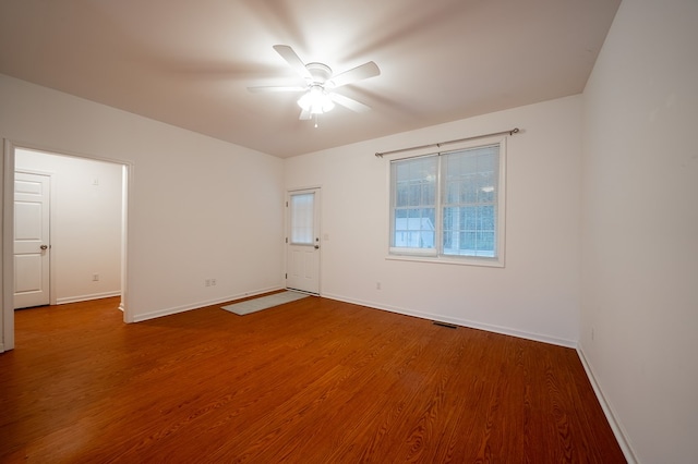 spare room featuring hardwood / wood-style floors and ceiling fan