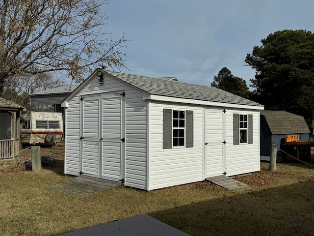 view of outdoor structure featuring a lawn