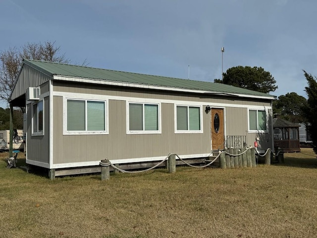 rear view of property with a lawn