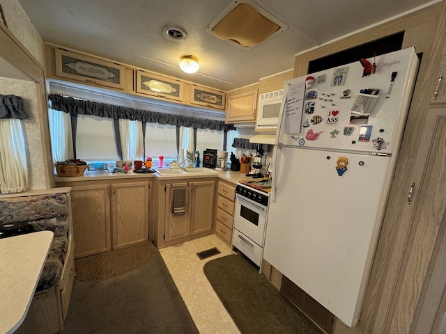 kitchen with sink and white appliances