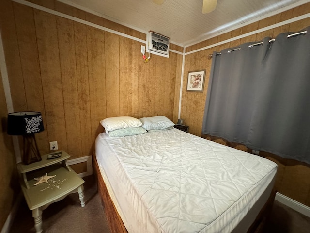 bedroom featuring ceiling fan and wooden walls