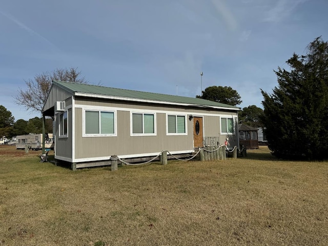 back of house with a lawn