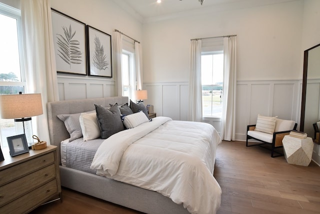 bedroom featuring hardwood / wood-style floors and ornamental molding