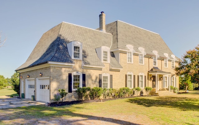 view of front facade with a front yard and a garage