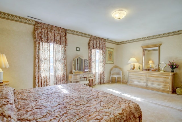 bedroom with light colored carpet and multiple windows