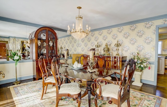 dining space featuring dark hardwood / wood-style flooring, crown molding, and a notable chandelier