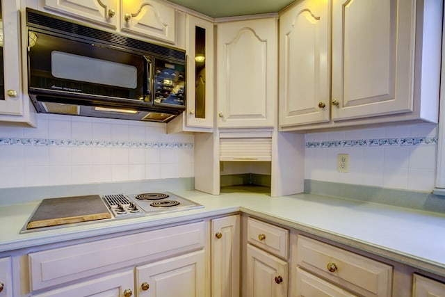 kitchen featuring cooktop and tasteful backsplash