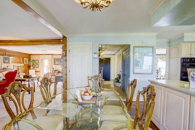 dining area featuring crown molding and a notable chandelier