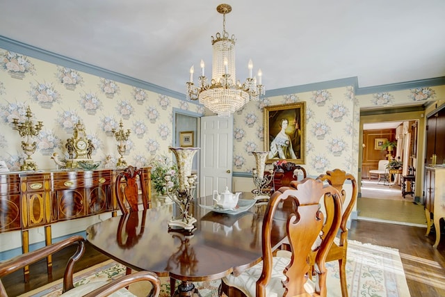 dining room with crown molding, hardwood / wood-style floors, and a notable chandelier