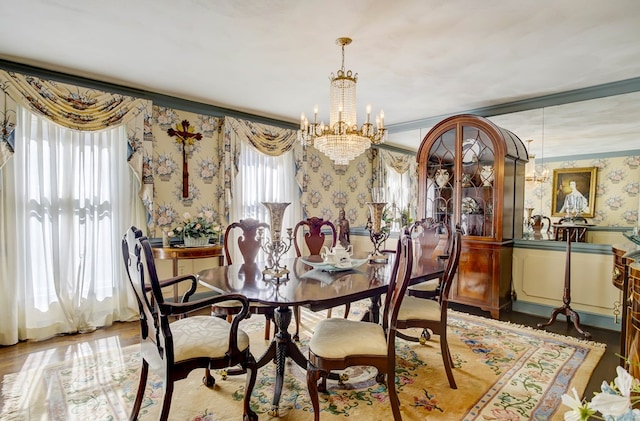 dining room with hardwood / wood-style floors, an inviting chandelier, and ornamental molding