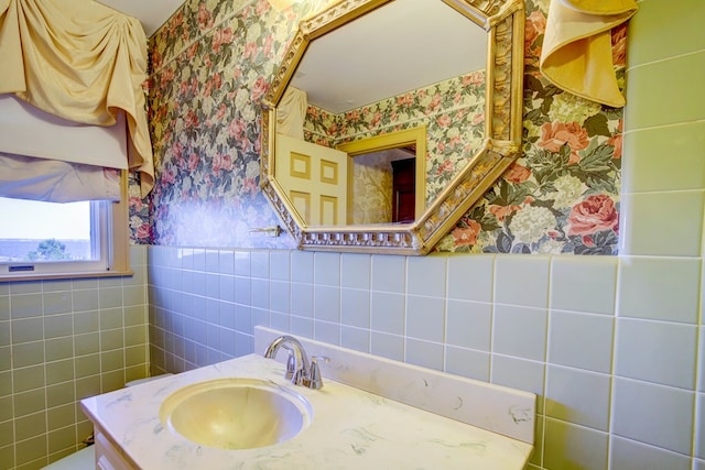 bathroom featuring vanity and tile walls