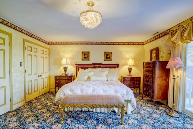 bedroom with carpet flooring and a chandelier