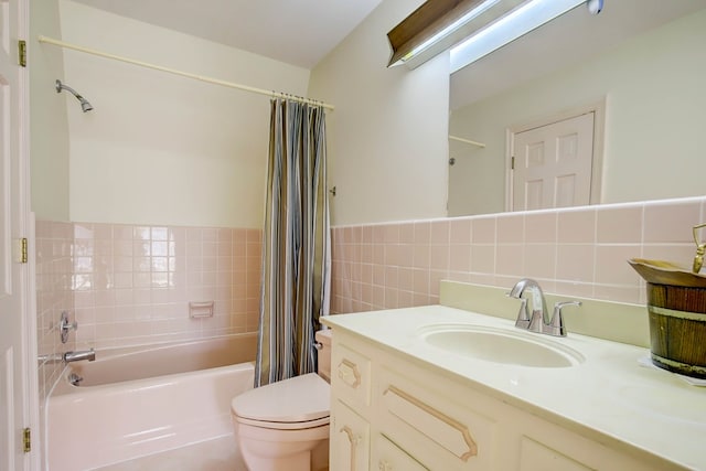 full bathroom with shower / tub combo, vanity, toilet, and tile walls