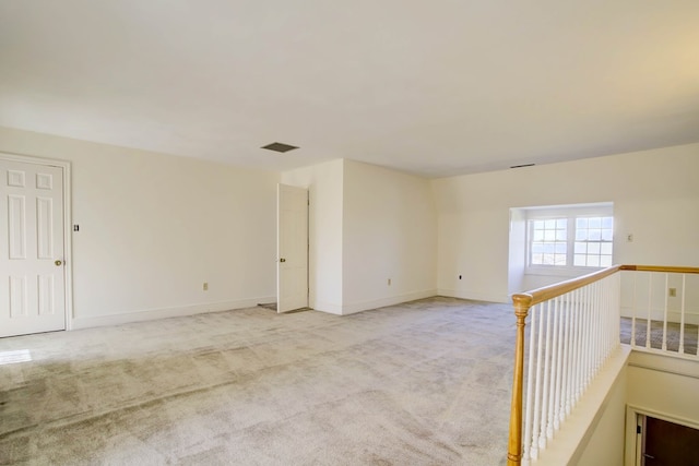 spare room with light colored carpet