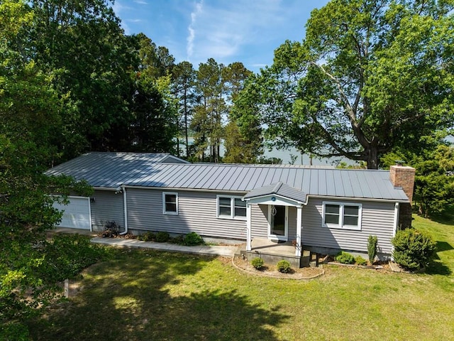 31510 Sunset Dr, Painter, VA 23420 - view of front of property featuring a front lawn, a standing seam roof, a chimney, and metal roof