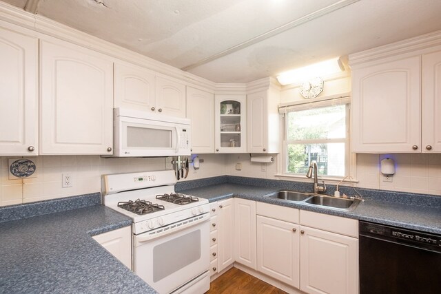 31510 Sunset Dr, Painter, VA 23420 - kitchen featuring white appliances, white cabinetry, dark countertops, and a sink