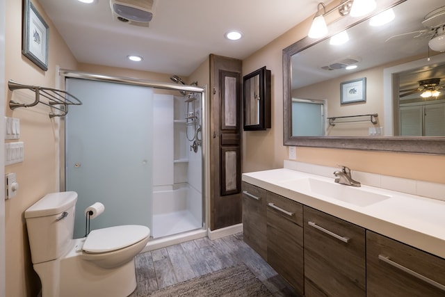 31510 Sunset Dr, Painter, VA 23420 - bathroom with vanity, a stall shower, wood finished floors, and toilet