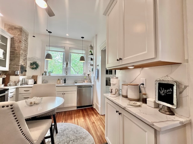2453 Sand Hill Dr, Cape Charles, VA 23310 - kitchen featuring stainless steel dishwasher, light wood-type flooring, white cabinetry, decorative light fixtures, and a ceiling fan