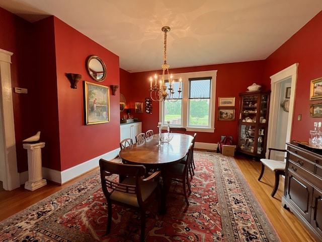 2453 Sand Hill Dr, Cape Charles, VA 23310 - dining room featuring light wood-style flooring, a chandelier, and baseboards