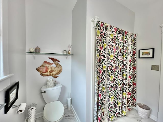2453 Sand Hill Dr, Cape Charles, VA 23310 - full bathroom featuring marble look tiles, toilet, a shower with curtain, and baseboards