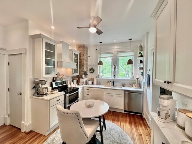 2453 Sand Hill Dr, Cape Charles, VA 23310 - kitchen featuring stainless steel appliances, premium range hood, light wood-style floors, a ceiling fan, and recessed lighting