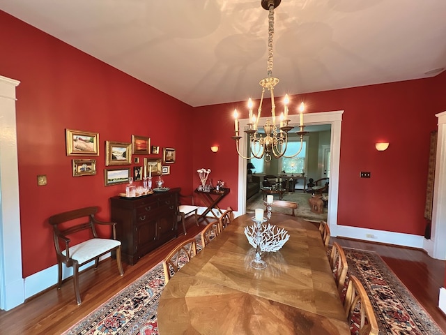 2453 Sand Hill Dr, Cape Charles, VA 23310 - dining area with a chandelier, wood finished floors, and baseboards