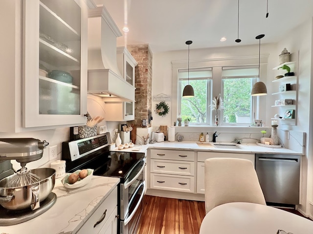 2453 Sand Hill Dr, Cape Charles, VA 23310 - kitchen featuring appliances with stainless steel finishes, dark wood-style flooring, light stone countertops, pendant lighting, and white cabinets