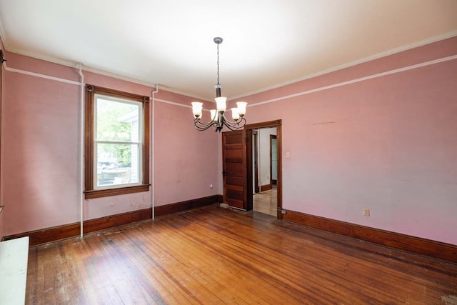 205 Monroe Ave, Cape Charles, VA 23310 - empty room with a chandelier, baseboards, hardwood / wood-style flooring, and crown molding