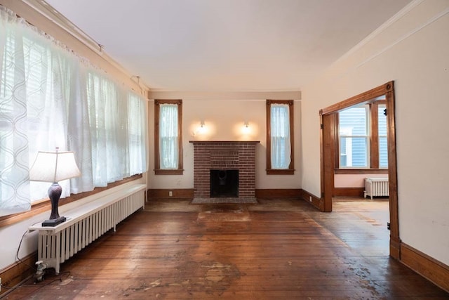 205 Monroe Ave, Cape Charles, VA 23310 - living room featuring radiator heating unit, hardwood / wood-style floors, a brick fireplace, baseboards, and crown molding