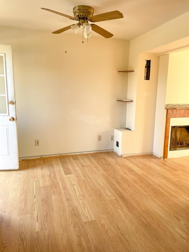 unfurnished living room with ceiling fan and light hardwood / wood-style floors