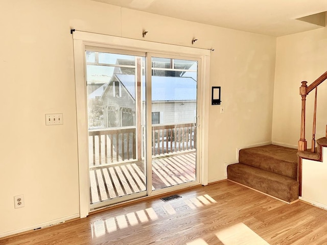 doorway to outside with light wood-type flooring