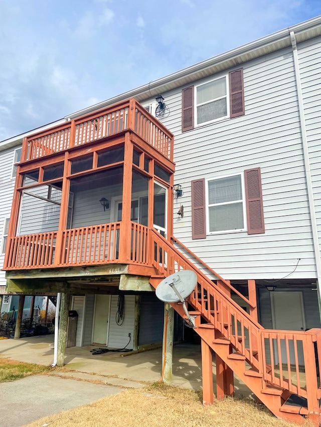 rear view of house featuring a patio area and a sunroom