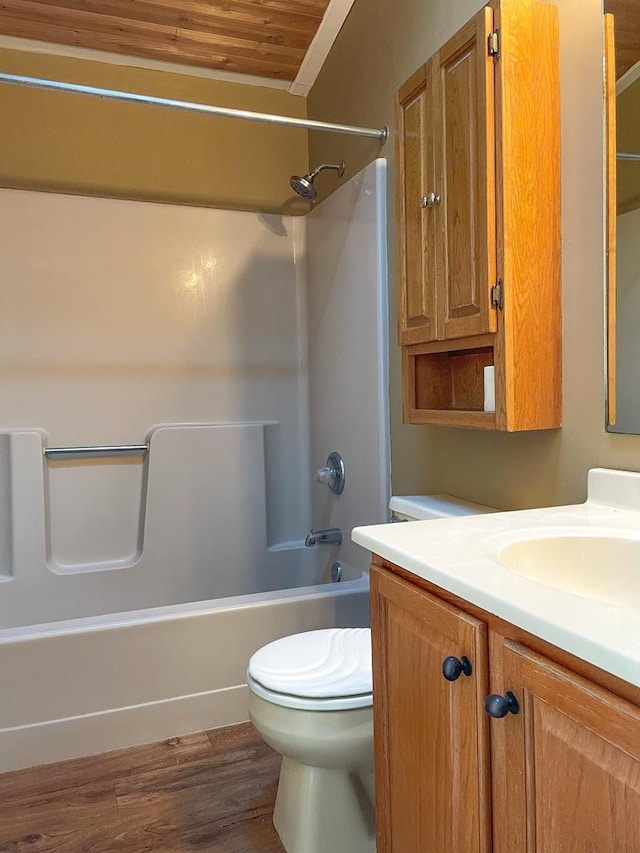 full bathroom with wood-type flooring, vanity, shower / bath combination, and toilet