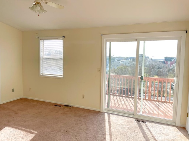 carpeted empty room featuring ceiling fan