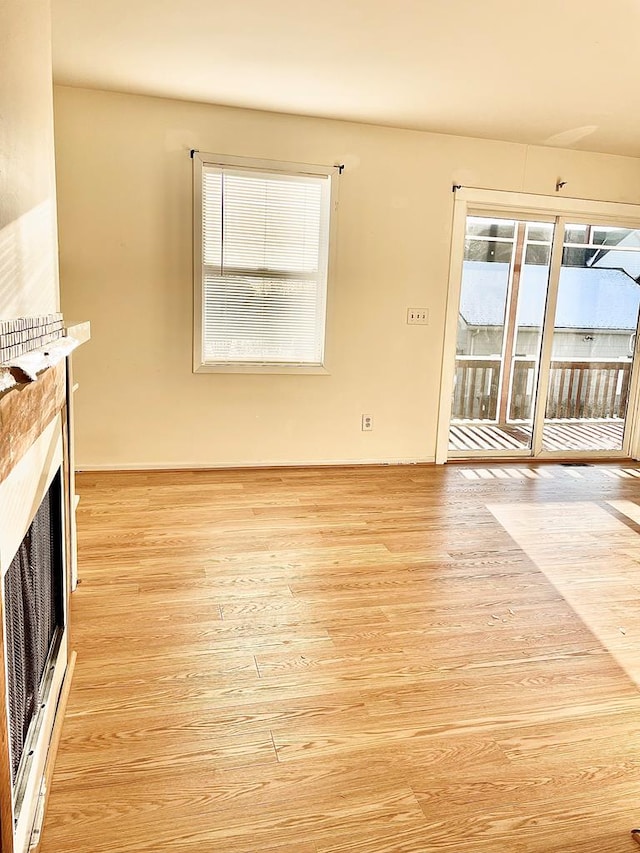 unfurnished living room with light wood-type flooring