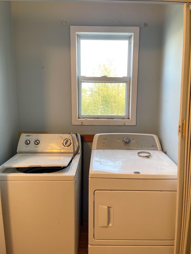 clothes washing area featuring washer and dryer