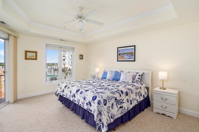 bedroom with access to exterior, ceiling fan, a raised ceiling, carpet, and ornamental molding