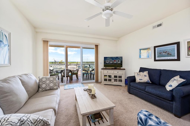 carpeted living room featuring ceiling fan