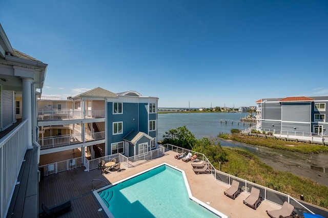 view of pool featuring a patio area and a water view