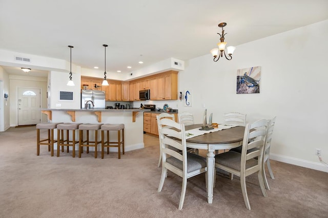 carpeted dining space featuring a notable chandelier